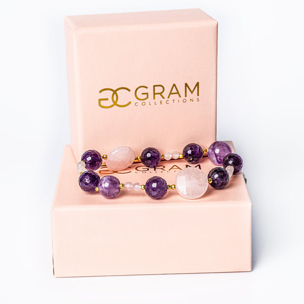 Orchid bracelet placed on its pink box. 