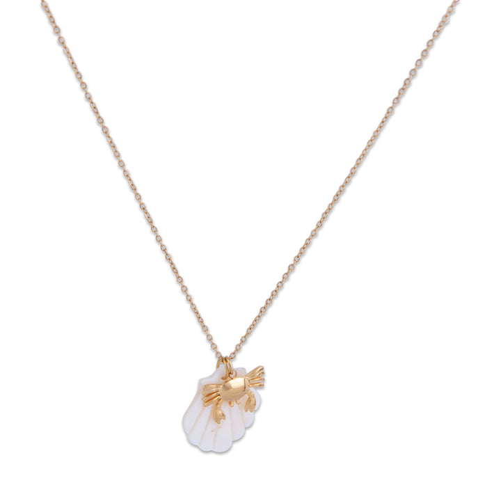 The Gram's Collection Anchor Bay Necklace with a white shell pendant and gold fish charm on a white background