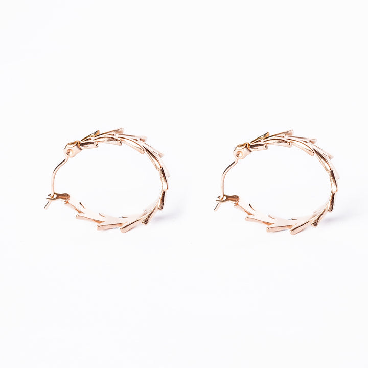 profile view of Antonella Rose Gold Earrings standing against a white background. 