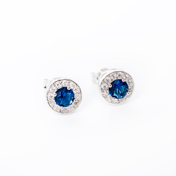 A close up view of Bailey earrings standing in the center of the image. 