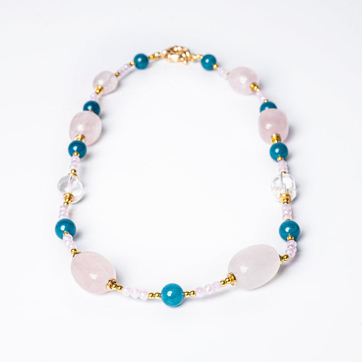 A yellow gold-plated stainless steel necklace with natural stones and pearls.