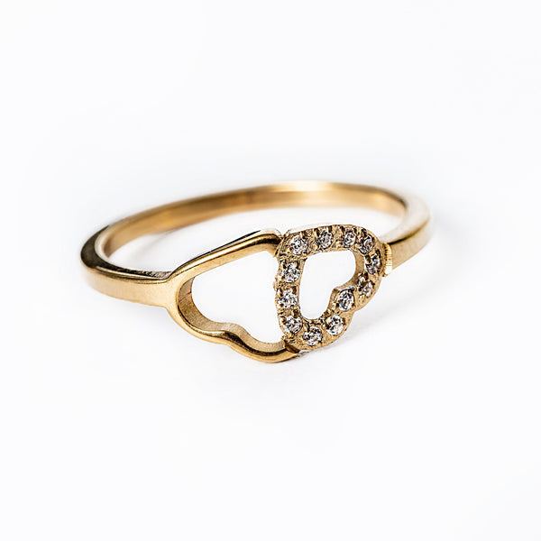 A gold-plated stainless steel ring with a yellow gold finish, featuring a heart-shaped setting with cubic zirconia accents.
