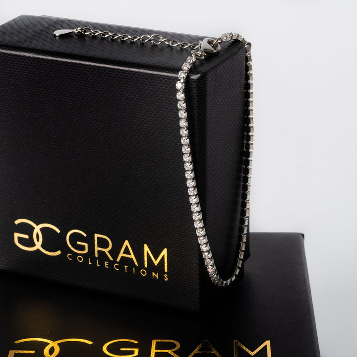 A Corra bracelet attached on a side of its black box. 