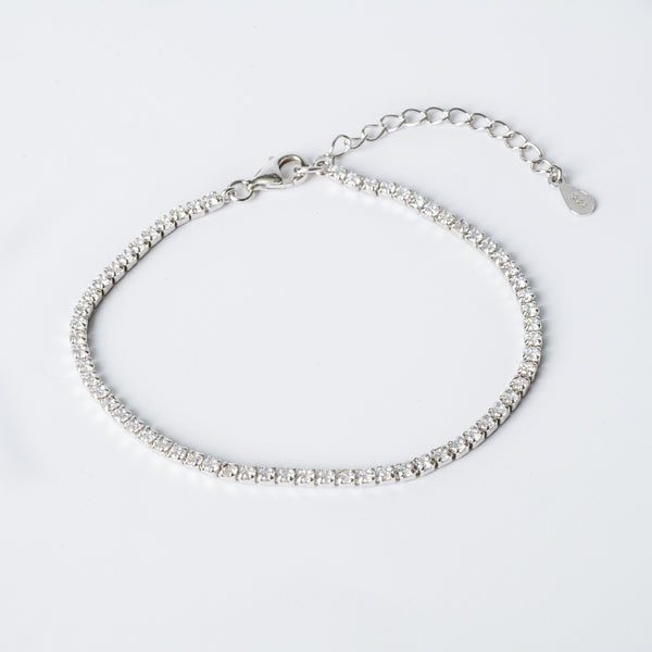 A sterling silver Cora bracelet with hypoallergenic cubic zirconia embellishments, featuring a chain structure and a lobster clasp closure.