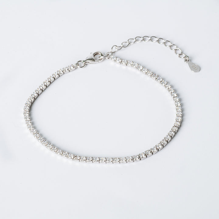 A sterling silver Cora bracelet with hypoallergenic cubic zirconia embellishments, featuring a chain structure and a lobster clasp closure.