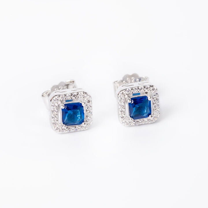 a blue stone Edith earrings close up against a white background. 