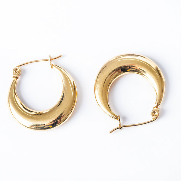 A pair of yellow gold hoop Evia earrings with a textured surface on a white background.