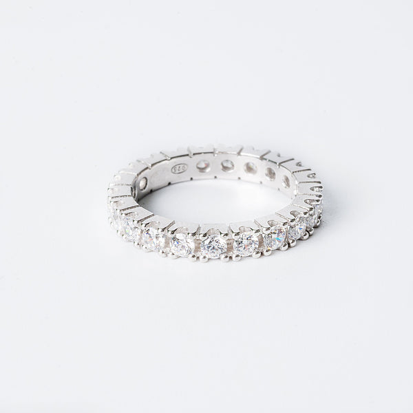 Fiona ring with multiple inset stones set around its circumference, standing against a white background. 