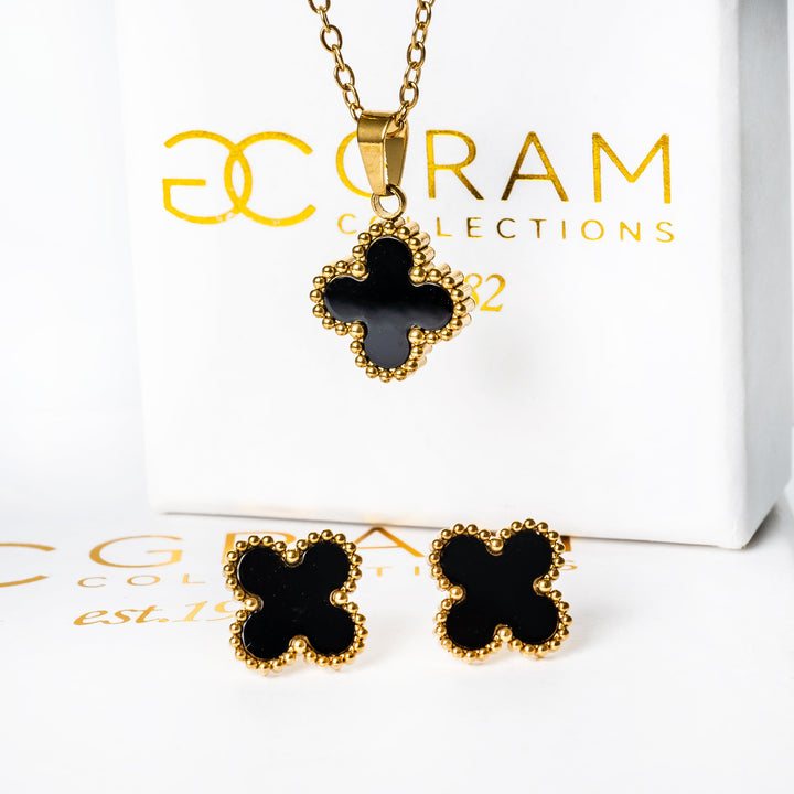 A close up view of Fiore Earrings standing in the center of the image against its beautifuly designed white box. 