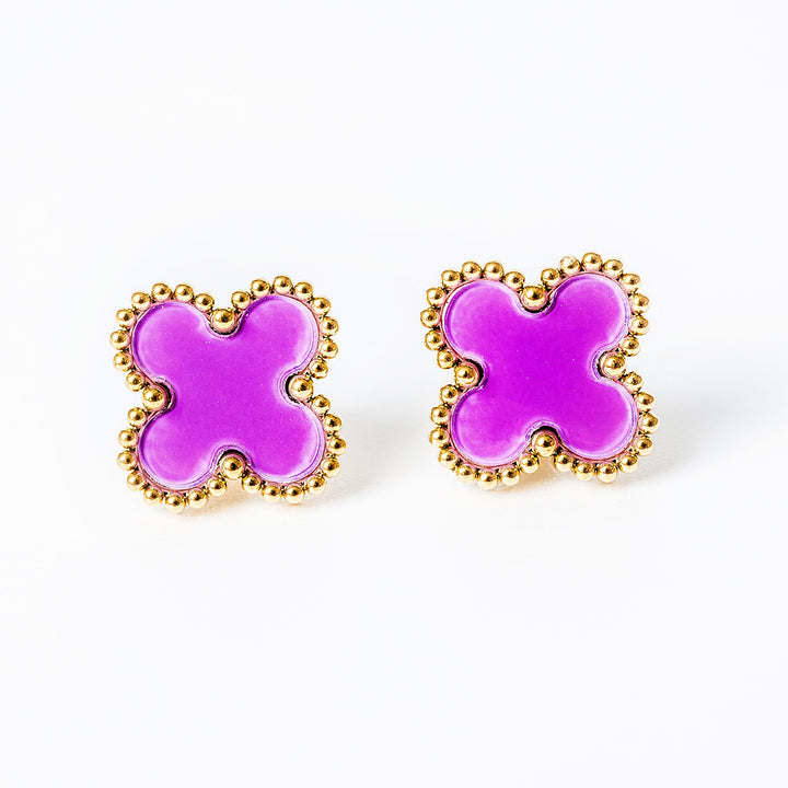 A close up view of Fiore earrings in pink colour standing in the center of the image 