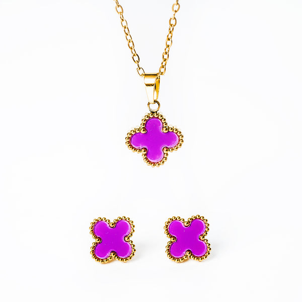 A close up view of Fiore jewelery set in ourple colour standing in the center of the image against a white background. 