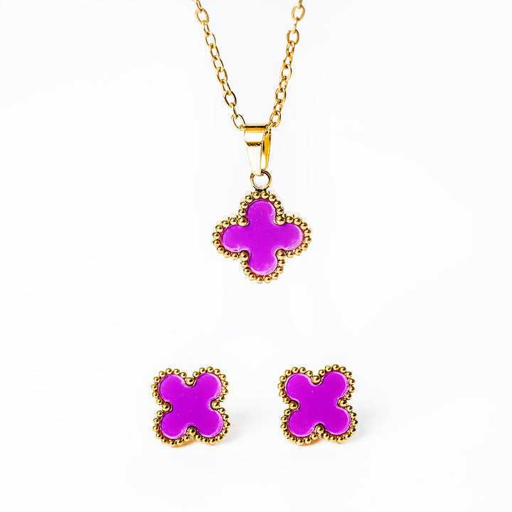 A close up view of Fiore jewelery set in ourple colour standing in the center of the image against a white background. 
