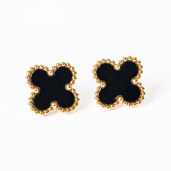 A close up view of Fiore earrings standing in the center of the image against a white background. 