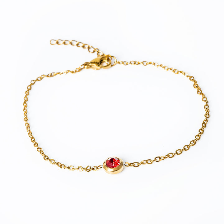 A close up view of Gabriella Gold Bracelet in red colour stone. 
