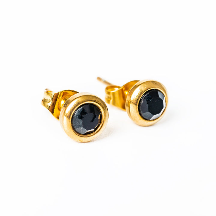 Close up view of Gabriella Gold Earrings with black pendants 