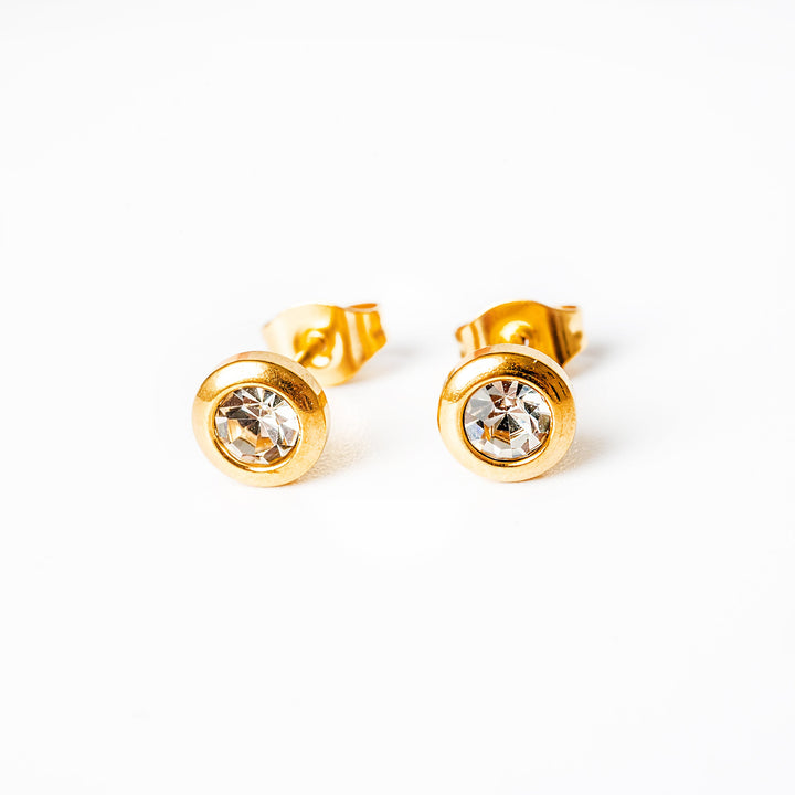 A close up view of Gabriella Gold Earrings with white pendant 
