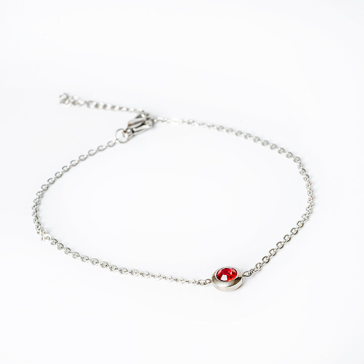 A close up view of Gabriella Silver Bracelet with red colour pendant 