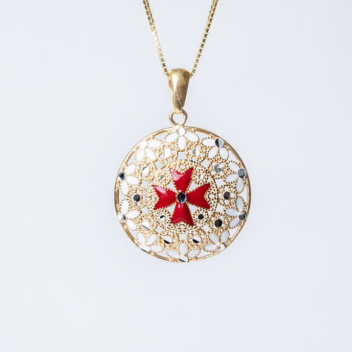 A sterling Gerit necklace with a yellow gold plated Maltese Cross pendant, featuring red and white enamel details, displayed against a white background.