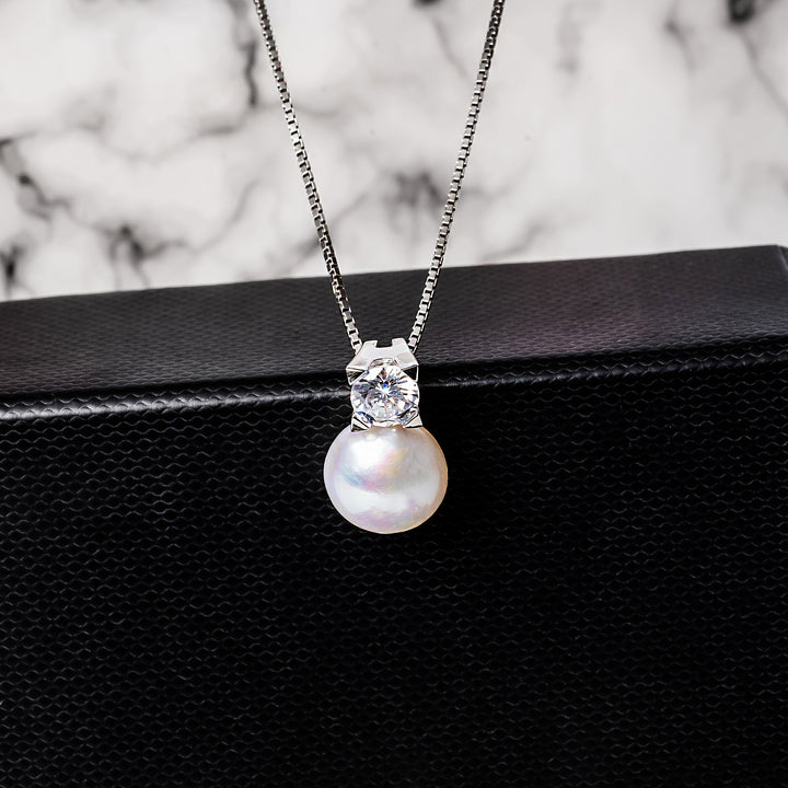 The close up view of Logan Necklace standing near its black box. 