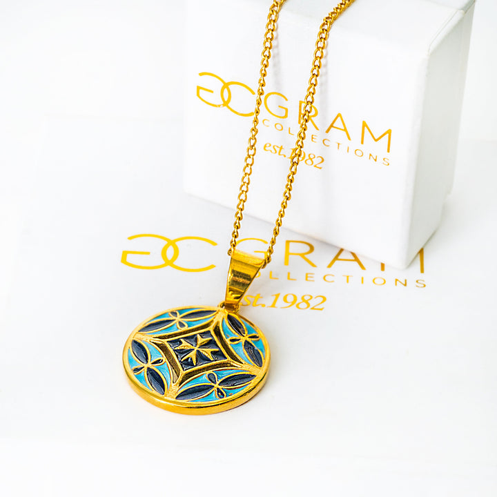 Gold necklace with a blue pendant on a white background with 'SOGRAM COLLECTIONS' branding.