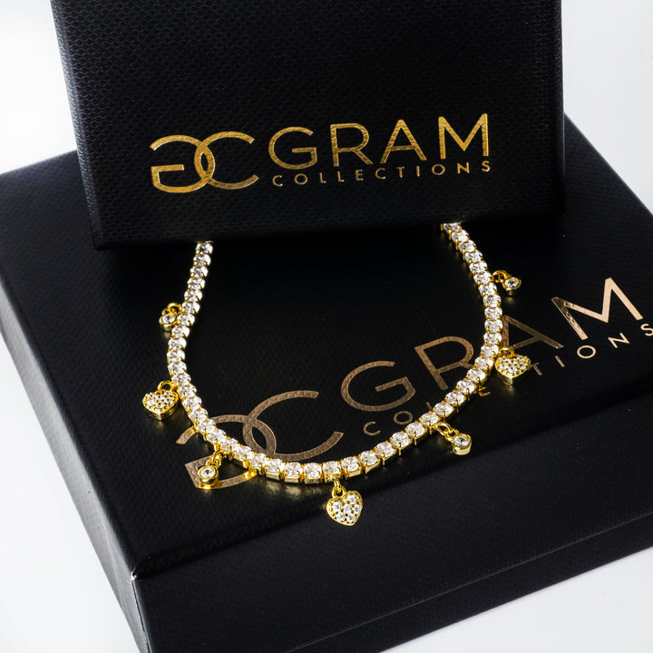 Gulia Necklace in between two boxes. 