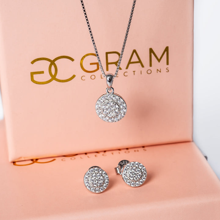 Hazel necklace and earrings placed on their uniquely designed pink box. 