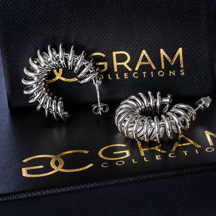 Ines Silver Earrings placed on their uniquely designed black box. 