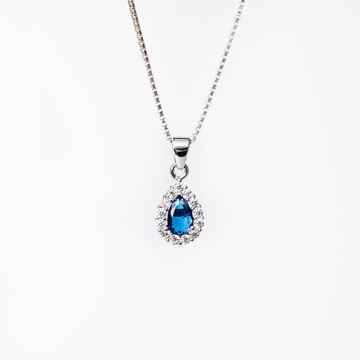 A close up view of Irene necklace standing against a white background. 