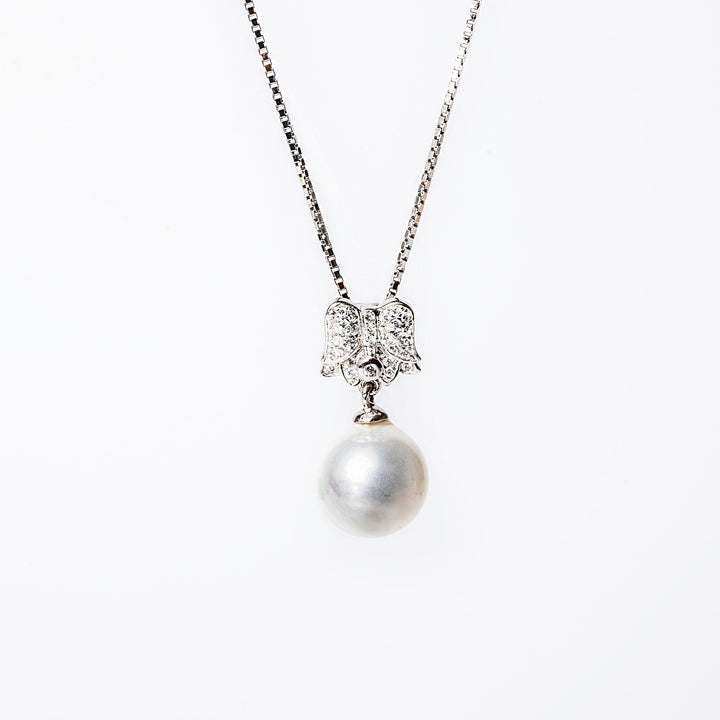 A sterling silver Lena necklace with a pendant featuring an intricate design, possibly an elephant, and a single pearl.