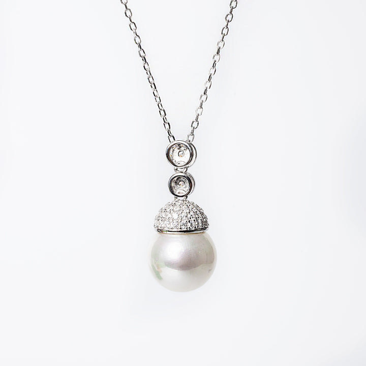 a close up view of Lieni Necklace standing in front of the image against a white background. 
