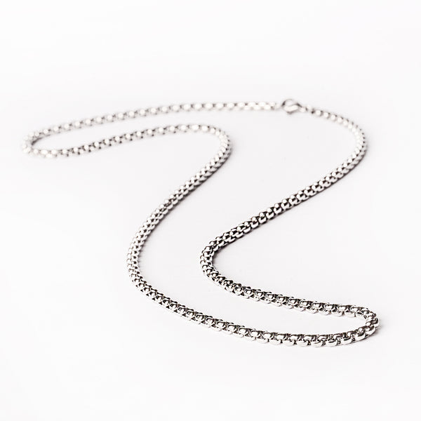 A silver stainless steel  Luccanecklace with a simple chain design on a white background.
