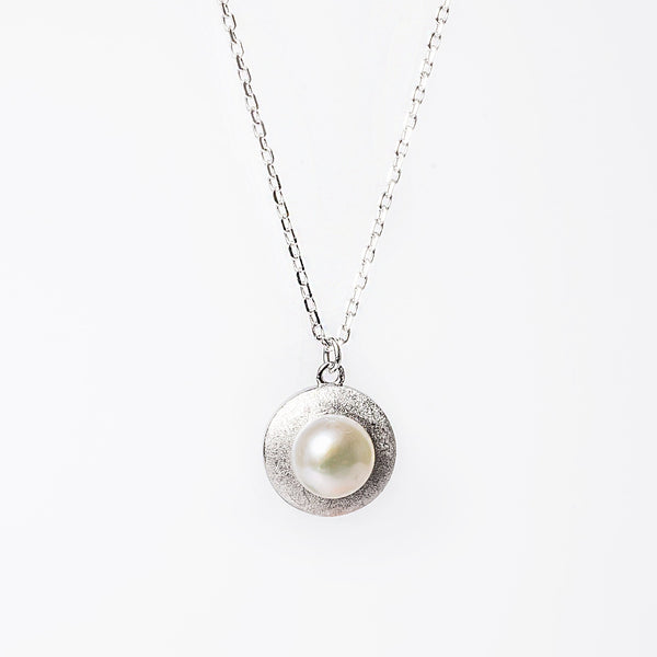 A close up view of Luidsy Necklace against a white background. 