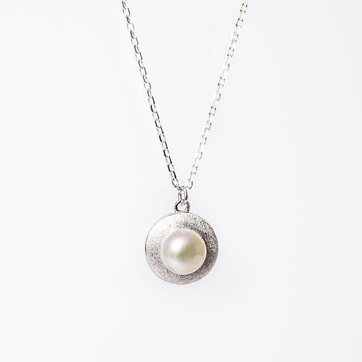 A close up view of Luidsy Necklace against a white background. 