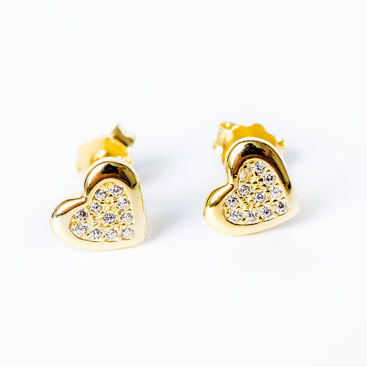 A close up view of Lydia earrings standing against a silver background. 