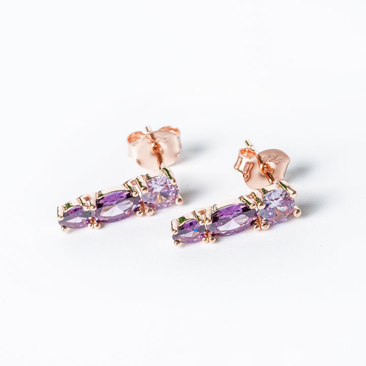 A marigold set of earrings placed in the center of the image against a white background. 