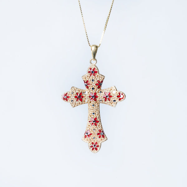 A sterling Marija necklace with a yellow gold cross pendant featuring red enamel accents, displayed against a white background.