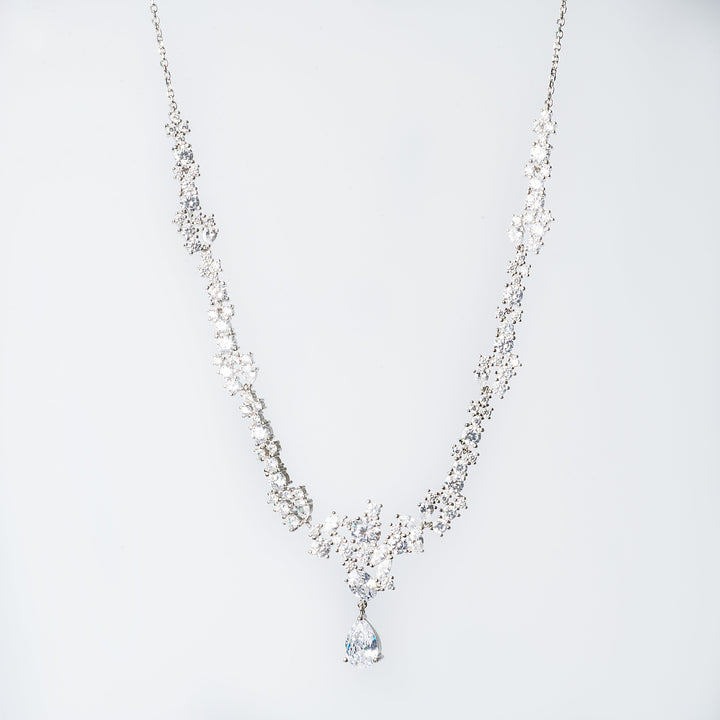 melissa earrings on necklace standing in the center of the image against a white background. 