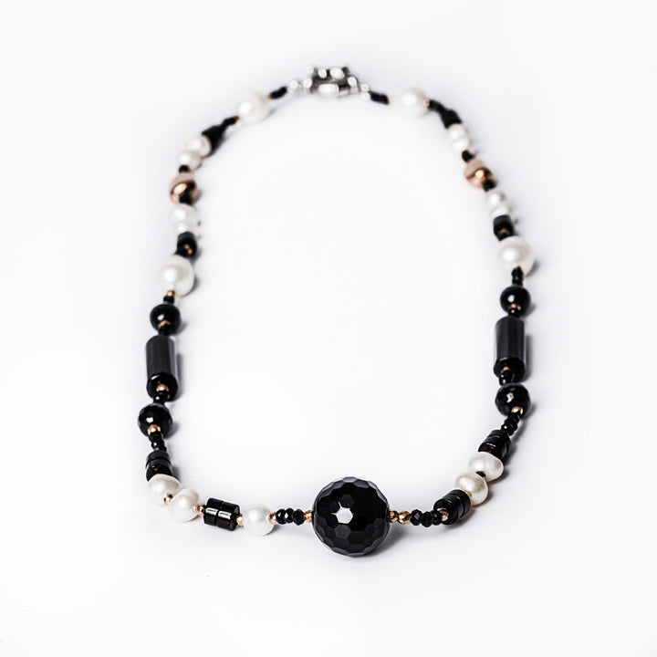 A birdview of a MoonLight Necklace  standing in the center of the image against a white background 
