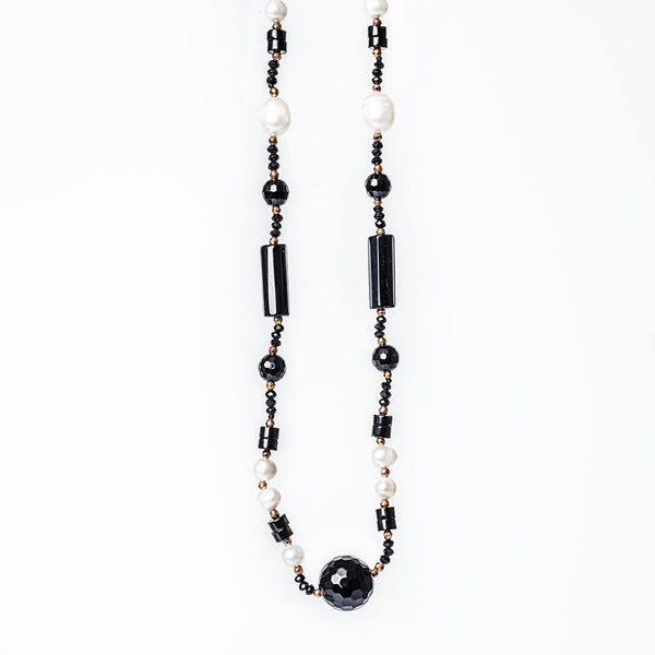 A close up view of MoonLight Necklace standing in the center of the image 
