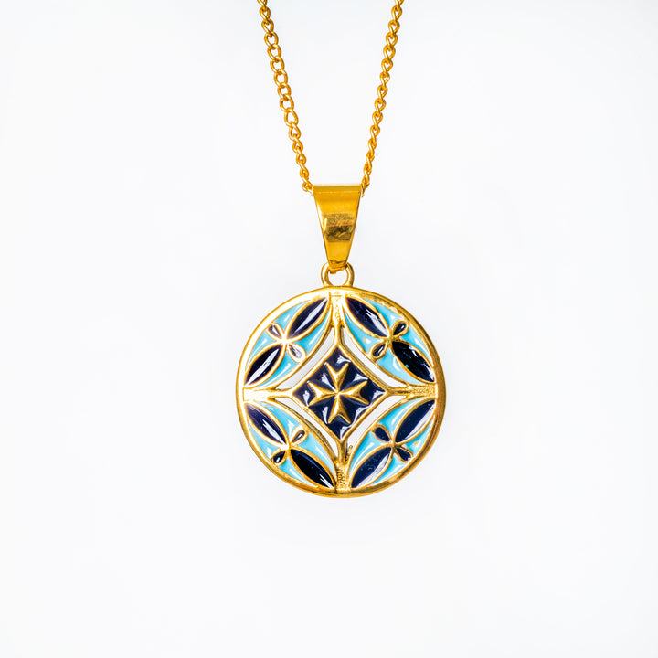 A gram collections Malta necklace's pendant standing in the center of the image against a white background. 