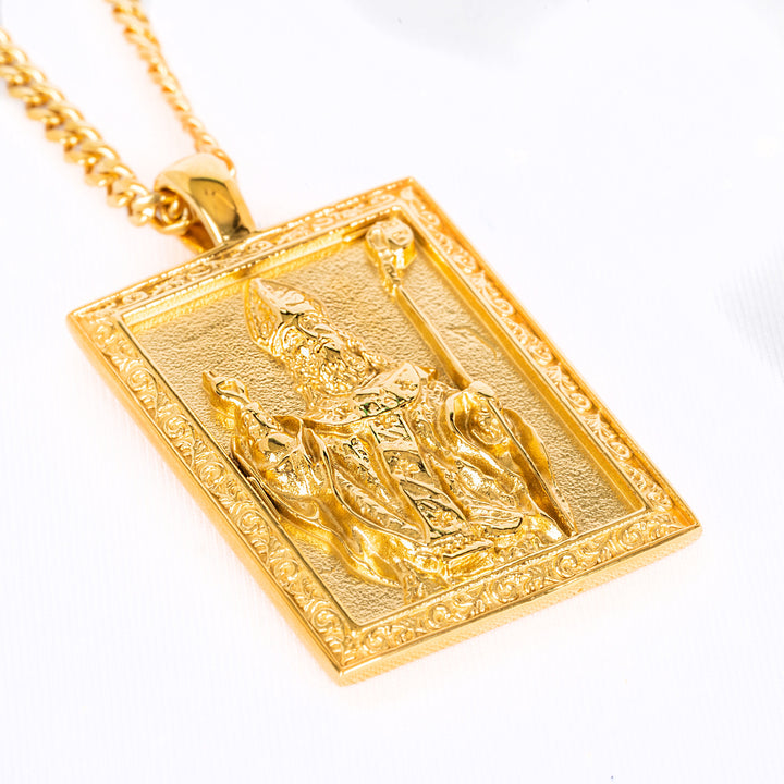 San Nikola Necklace placed on the bottom, seeing from a bird view, attached to its respectful chain standing against a white background. 