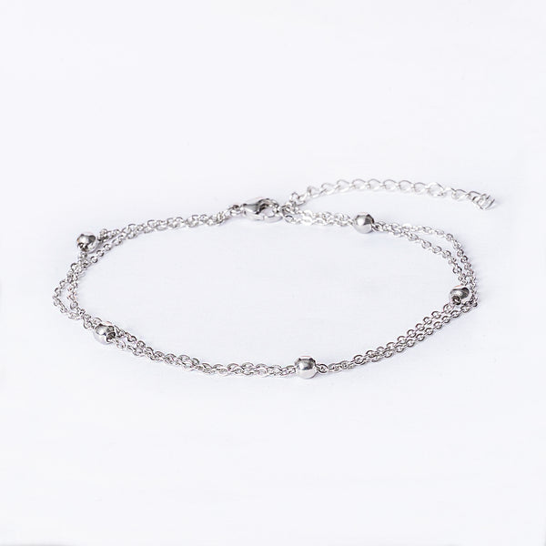 San Giljan Anklet seeing from front part, standing against a white background. 