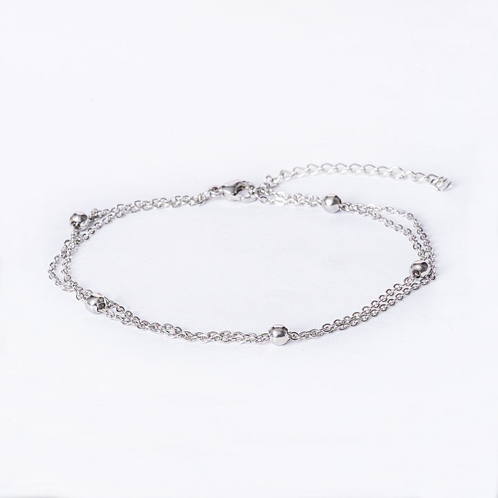 San Giljan Anklet seeing from front part, standing against a white background. 