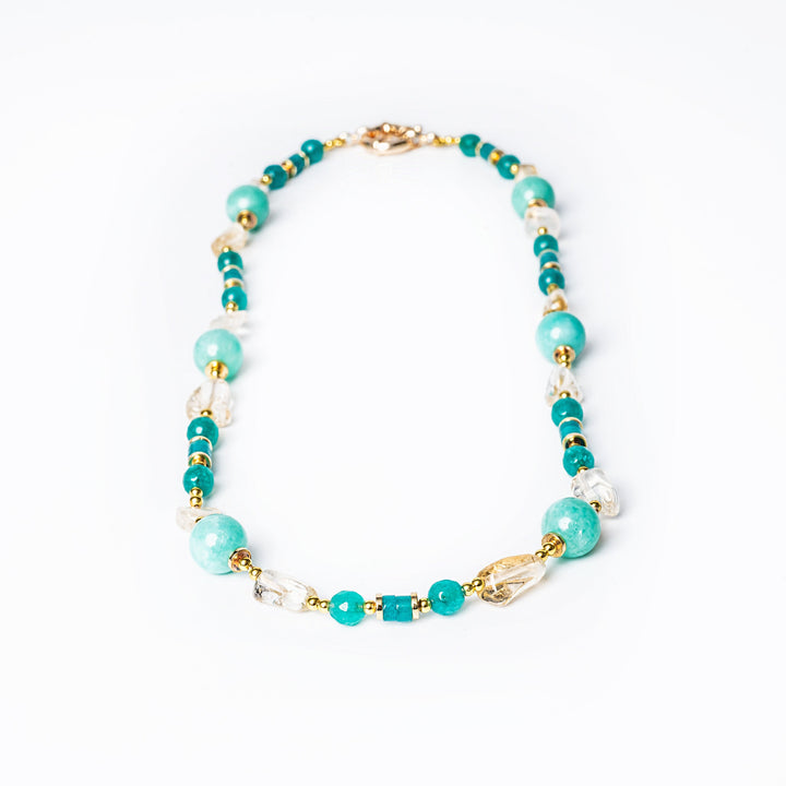 A yellow gold-plated stainless steel necklace with natural turquoise stones and white pearls