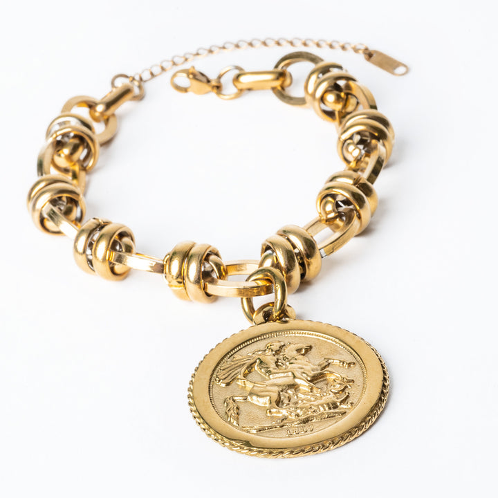 Ta' Lira Bracelet attached to its respectful chain standing against a white background 