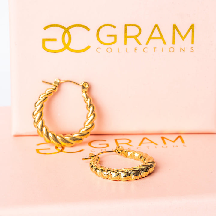 Tania Gold Earrings placed on ints uniquely designed box. 