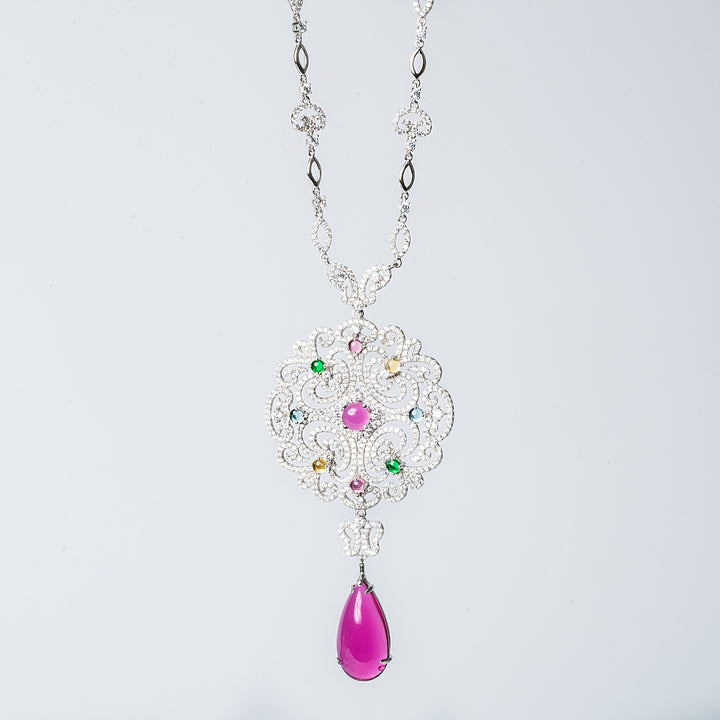 Taryn necklace with a floral pattern, featuring multicolored cubic zirconia stones and a single pearl-like bead.