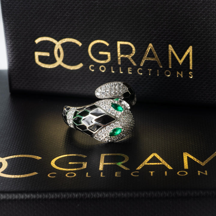 Velma Ring featuring a green cubic zirconia gemstone, surrounded by a layer of silver and possibly gold accents.