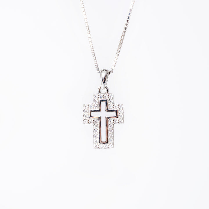 Close up view of Zelda cross standing in the center of the image against a white background. 