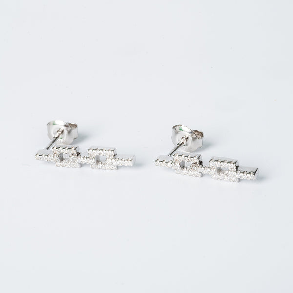 A pair of silver Alana earrings with cubic zirconia embellishments on a white background.